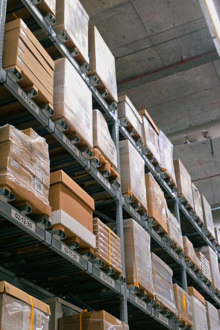A warehouse showcasing organized shelves with stacked cardboard boxes for storage and logistics.