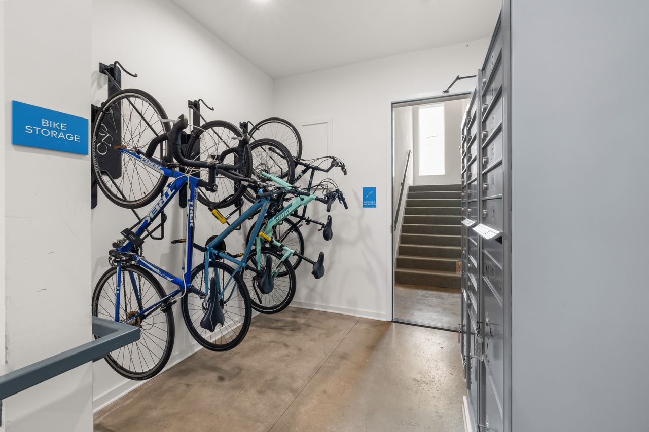 about-01 Modern indoor bike storage area with multiple bikes securely mounted on wall racks.
